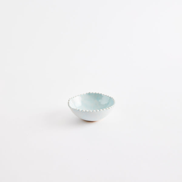 Baby blue pinch pot with scalloped edges.