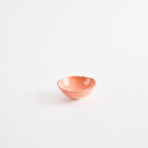 Peach pinch pot with scalloped edges.
