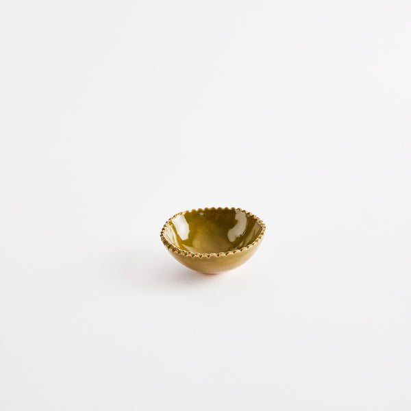 Olive green pinch pot with scalloped edges.
