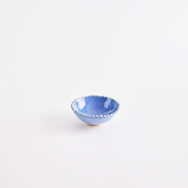Blue pinch pot with scalloped edges.