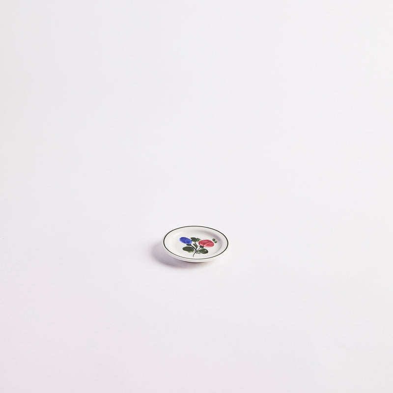 White with black edge and multicolour floral detail plate. 