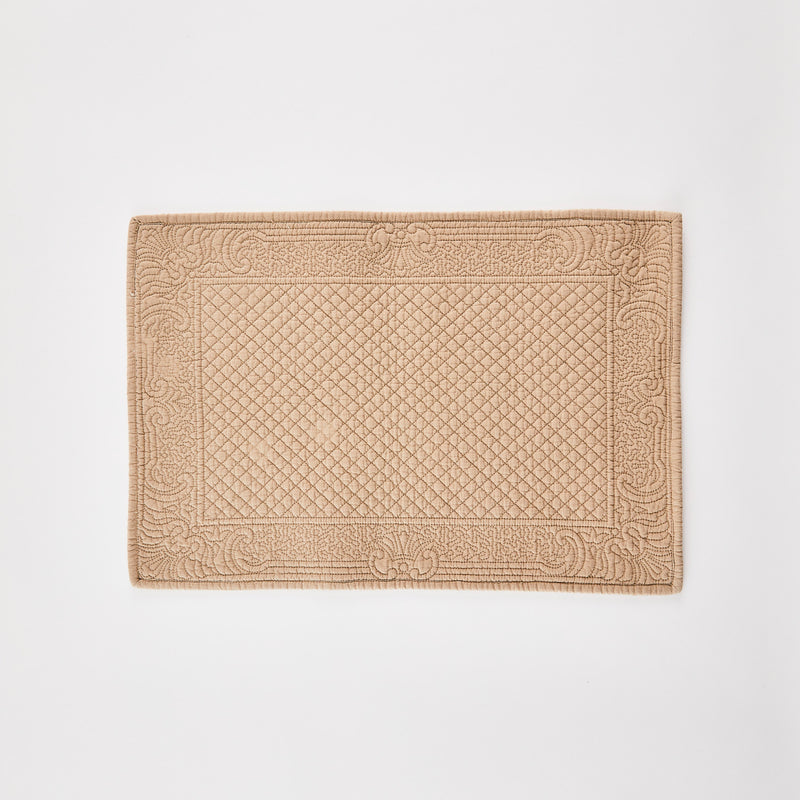 Beige quilted placemat.