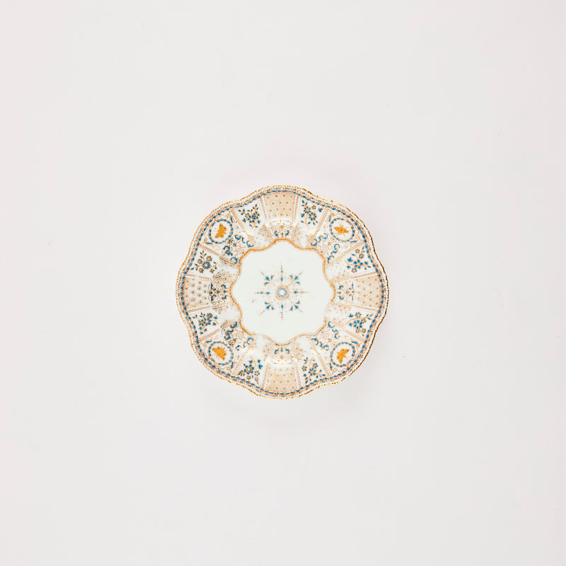 White plate with blue and gold pattern.