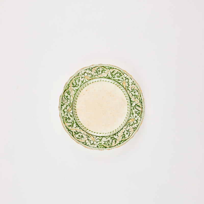 Cream plate with green leaf pattern edge.