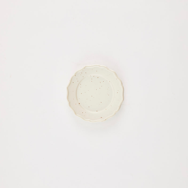 Cream plate with brown speckles.
