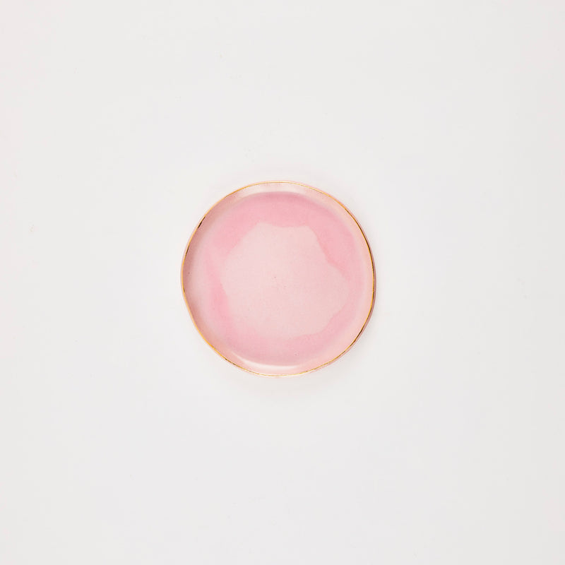 Pink plate with gold rim.