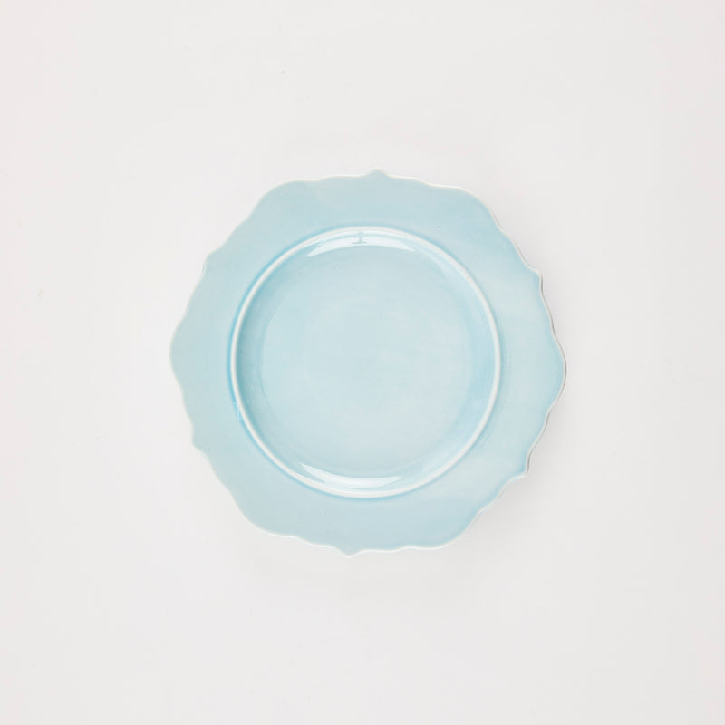 Baby blue plate with scallop edge.