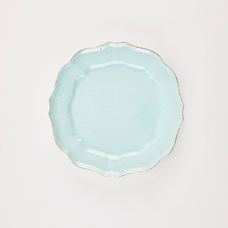 Baby blue plate with scallop edge and gold rim.
