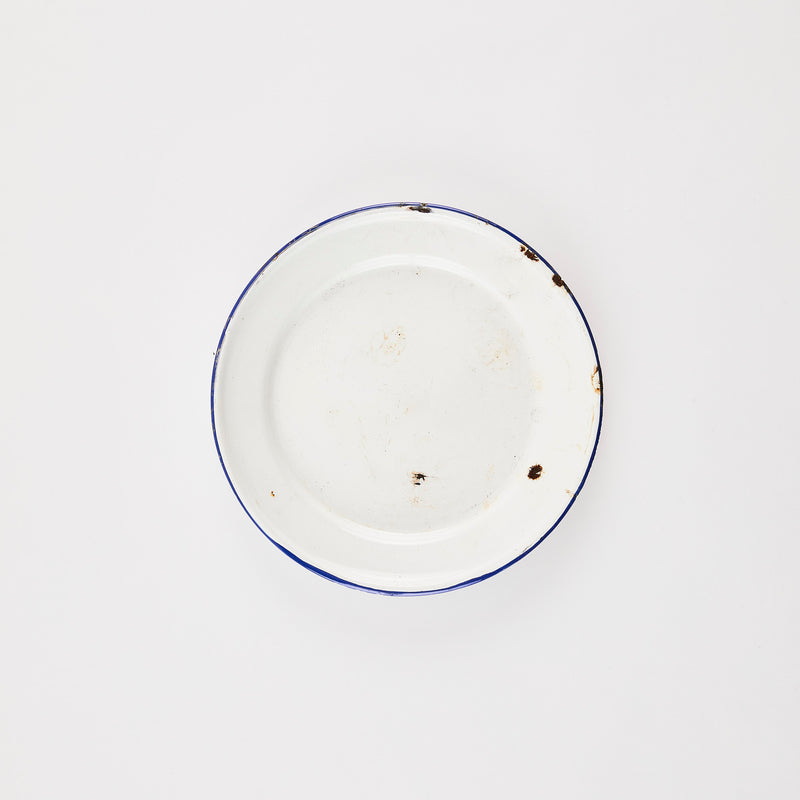 Rustic white plate with black rim.
