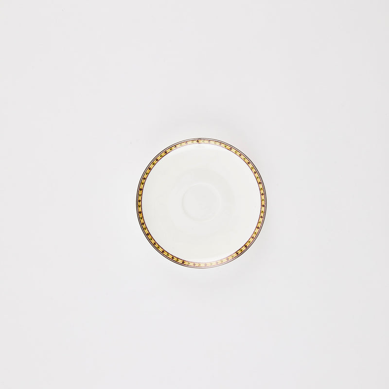 White plate with brown design rim.