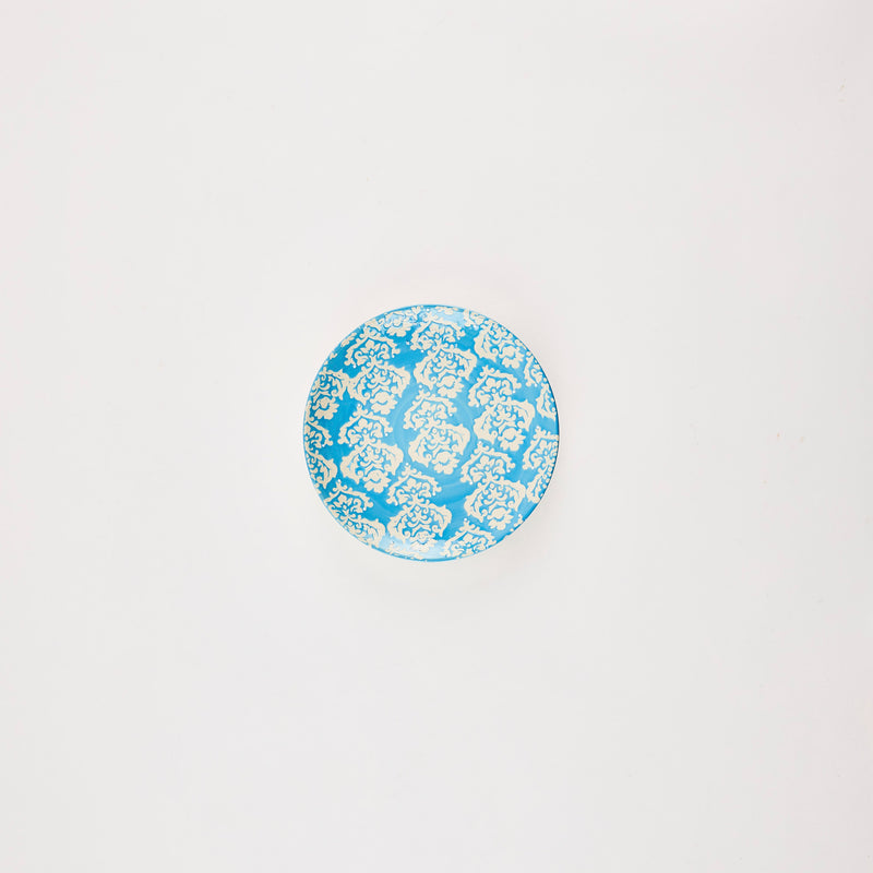 Blue plate with paisley detail.