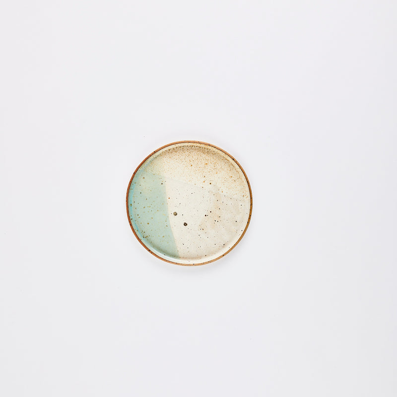 Light blue and beige plate with brown speckles and rim.