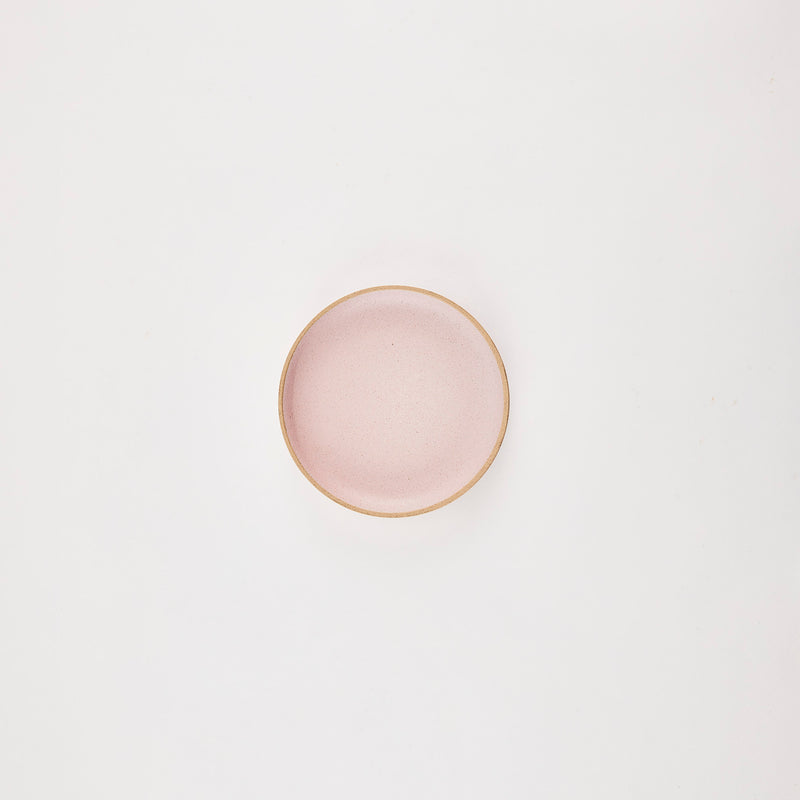 Pink plate with brown rim.