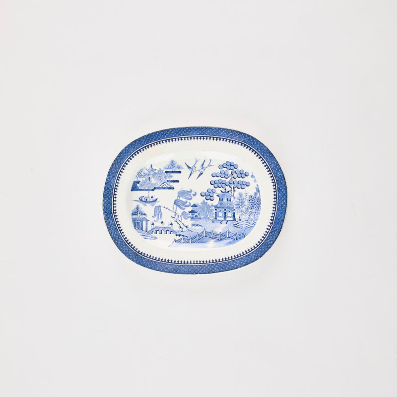 White and blue plate with Japanese design in the middle. 