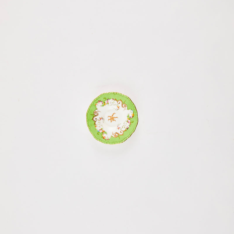 White plate with green rim and floral detail.