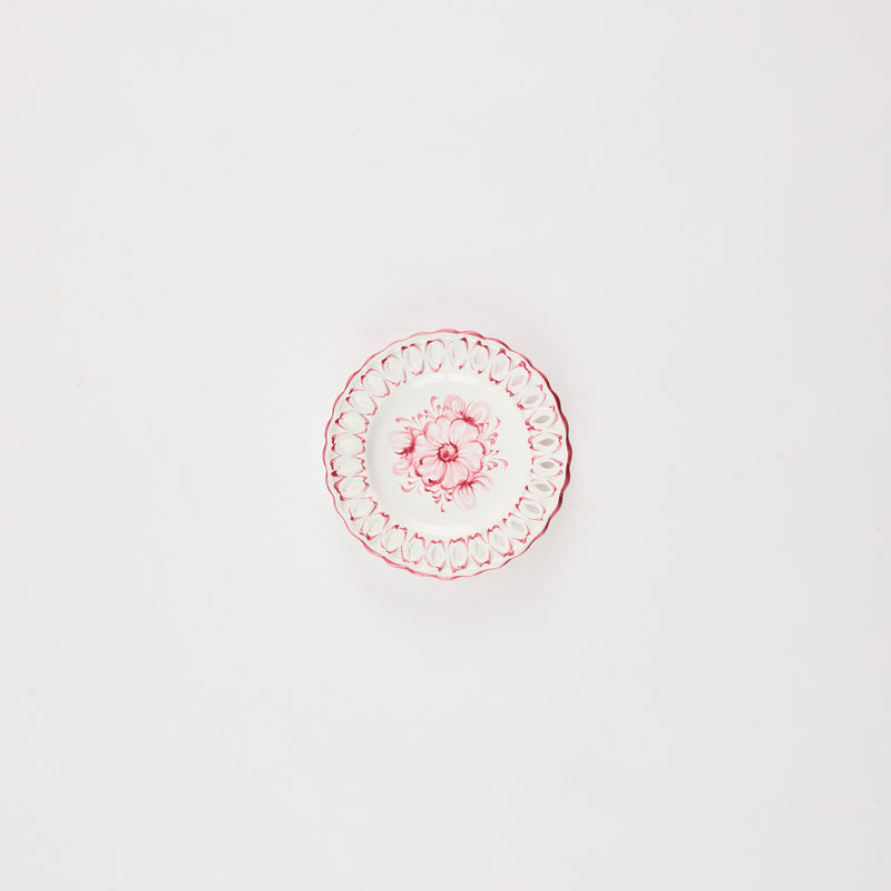 White plate with pink floral detail.