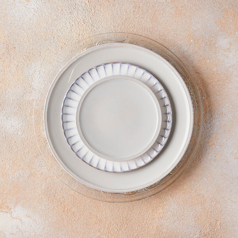 clear, white and gray mixed plate settings on peach mixed background.
