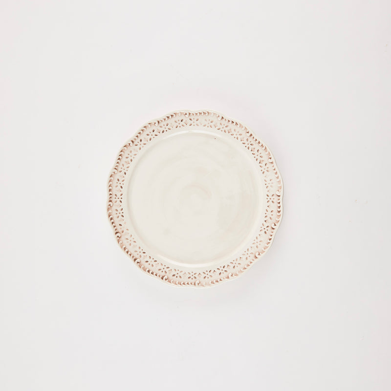 Cream platter with intricate design rim.