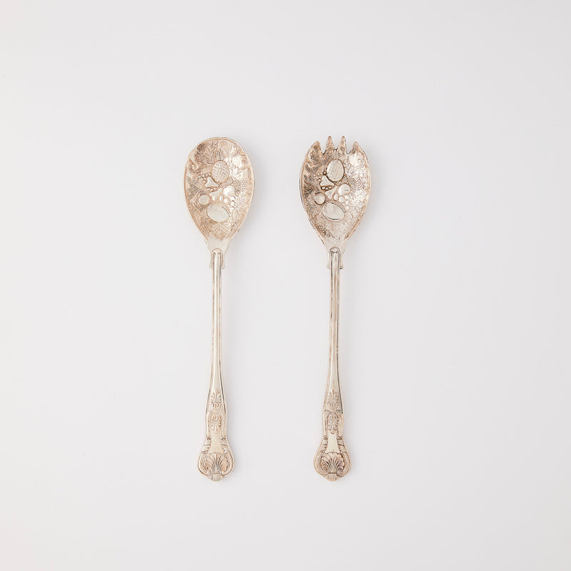 Silver serving cutlery with embossed design.