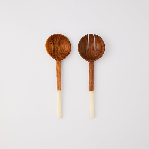 Wooden serving cutlery with white handle.