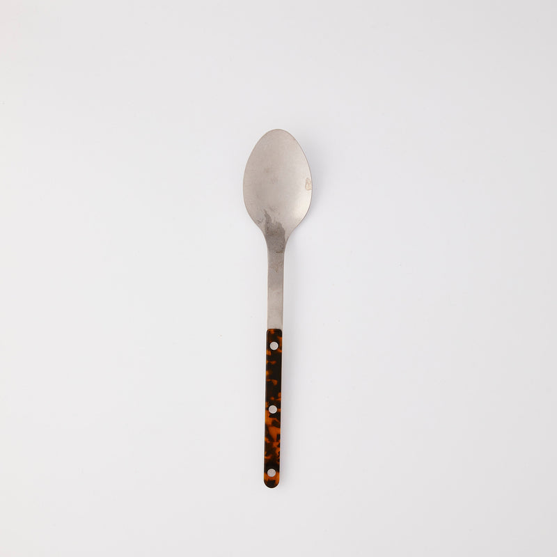 Silver serving spoon with tortoise handle.