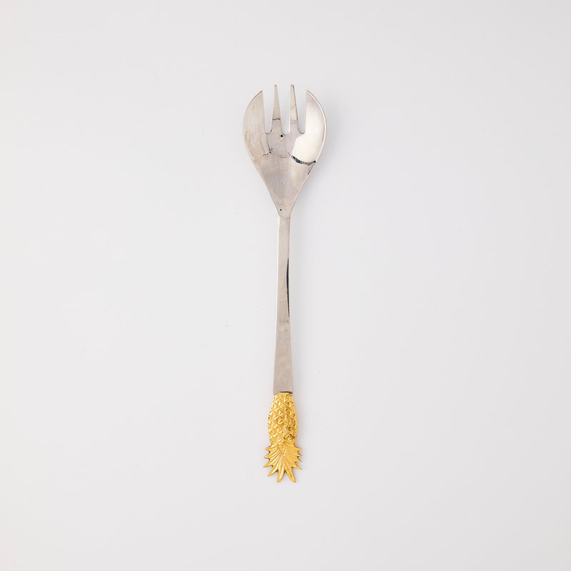 Silver serving fork with gold pineapple handle.