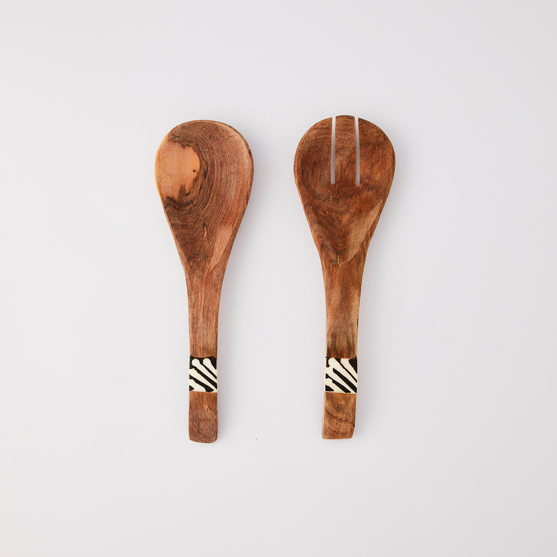 Wooden serving cutlery with white and black design block handle.