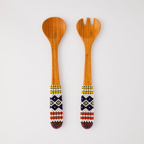 Wooden serving cutlery with multicolour design handle.