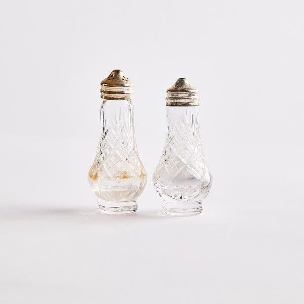 Clear glass with silver top shakers.