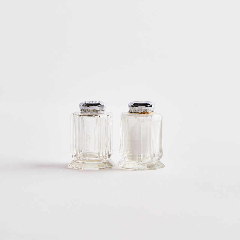 Clear glass with silver top shakers.