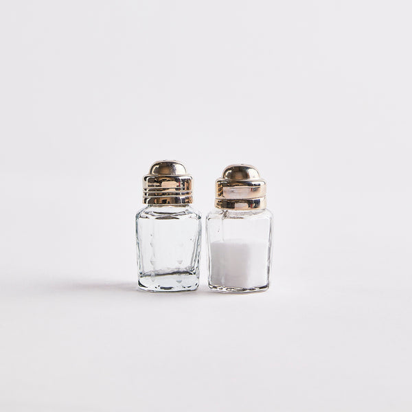 Clear glass with silver top shakers.