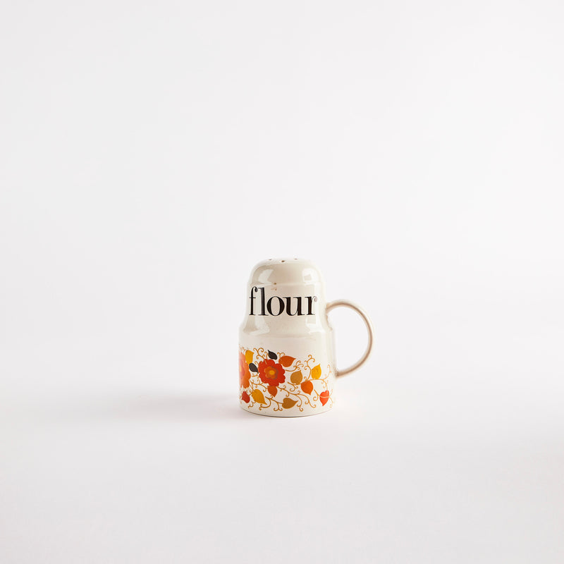 Vintage floral shaker with "flour" text.