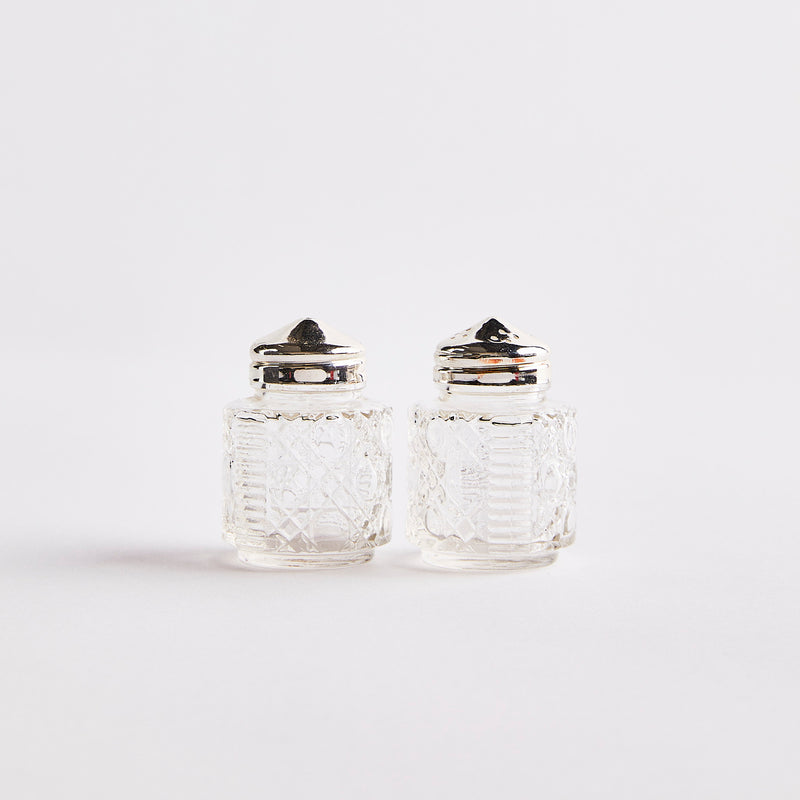 Glass with silver top shakers.