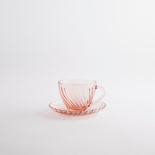 Pink glass tea cup and saucer.