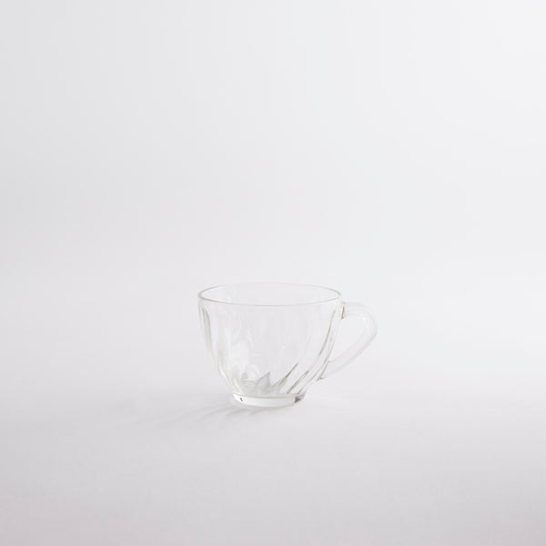 Clear glass tea cup.