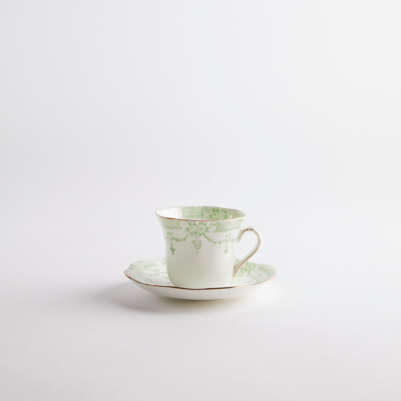 White with green vintage design tea cup and saucer.