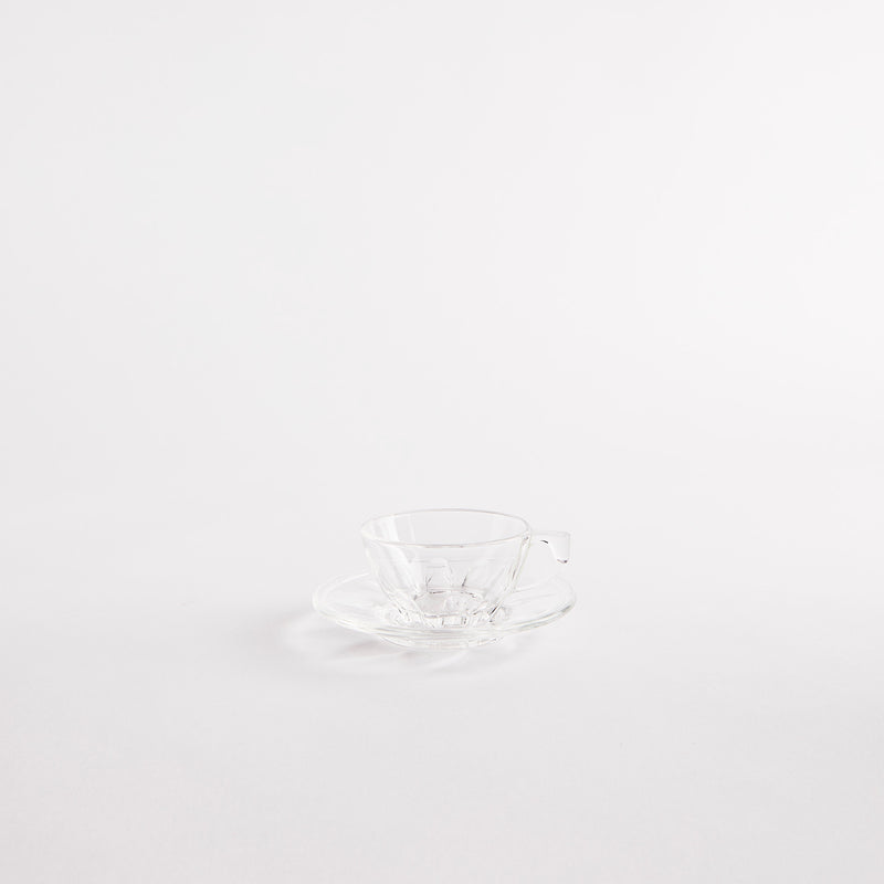 Clear glass teacup and saucer.