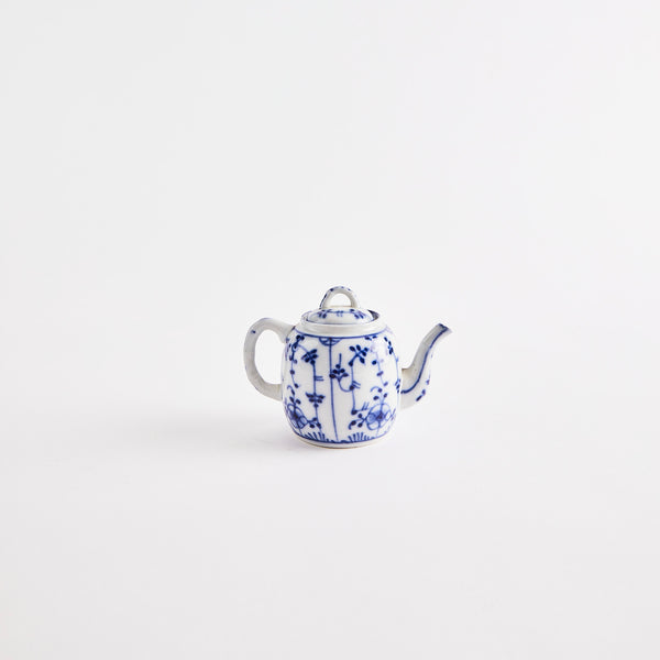 White teapot with blue floral design.