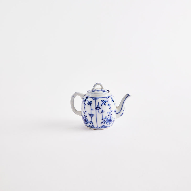 White teapot with blue floral design.