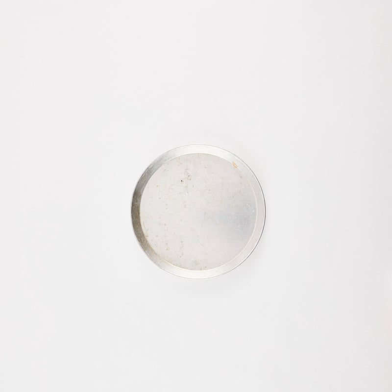 Silver circular tray.