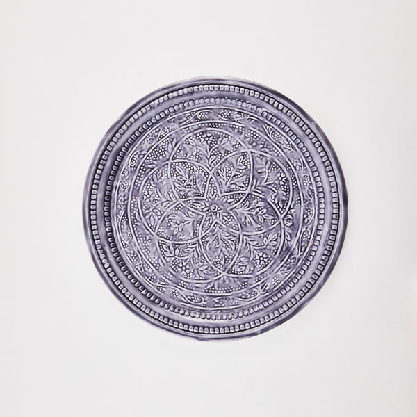 Blue circular tray with spiral detail.