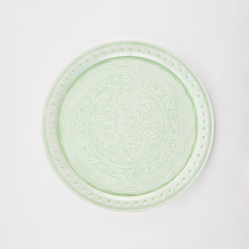 Green circular tray with spiral detail.