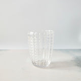 Clear with white dotted design glass tumbler.