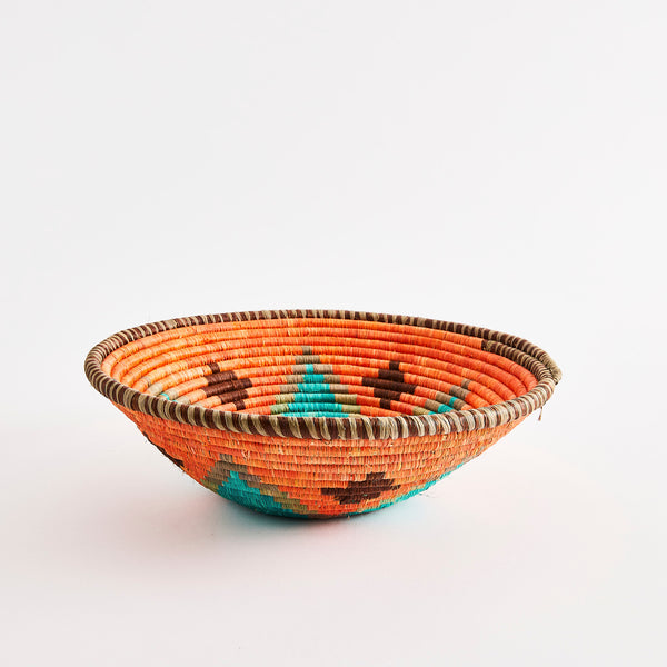 Orange and blue design with brown rim woven basket. 