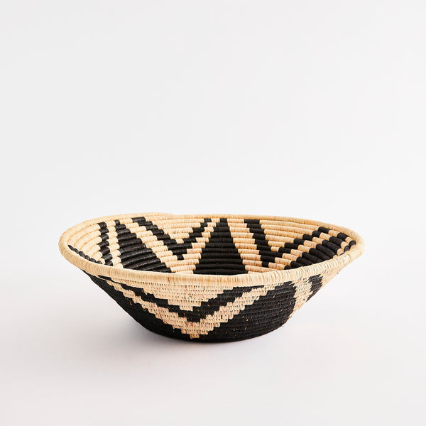 Woven basket with black design.